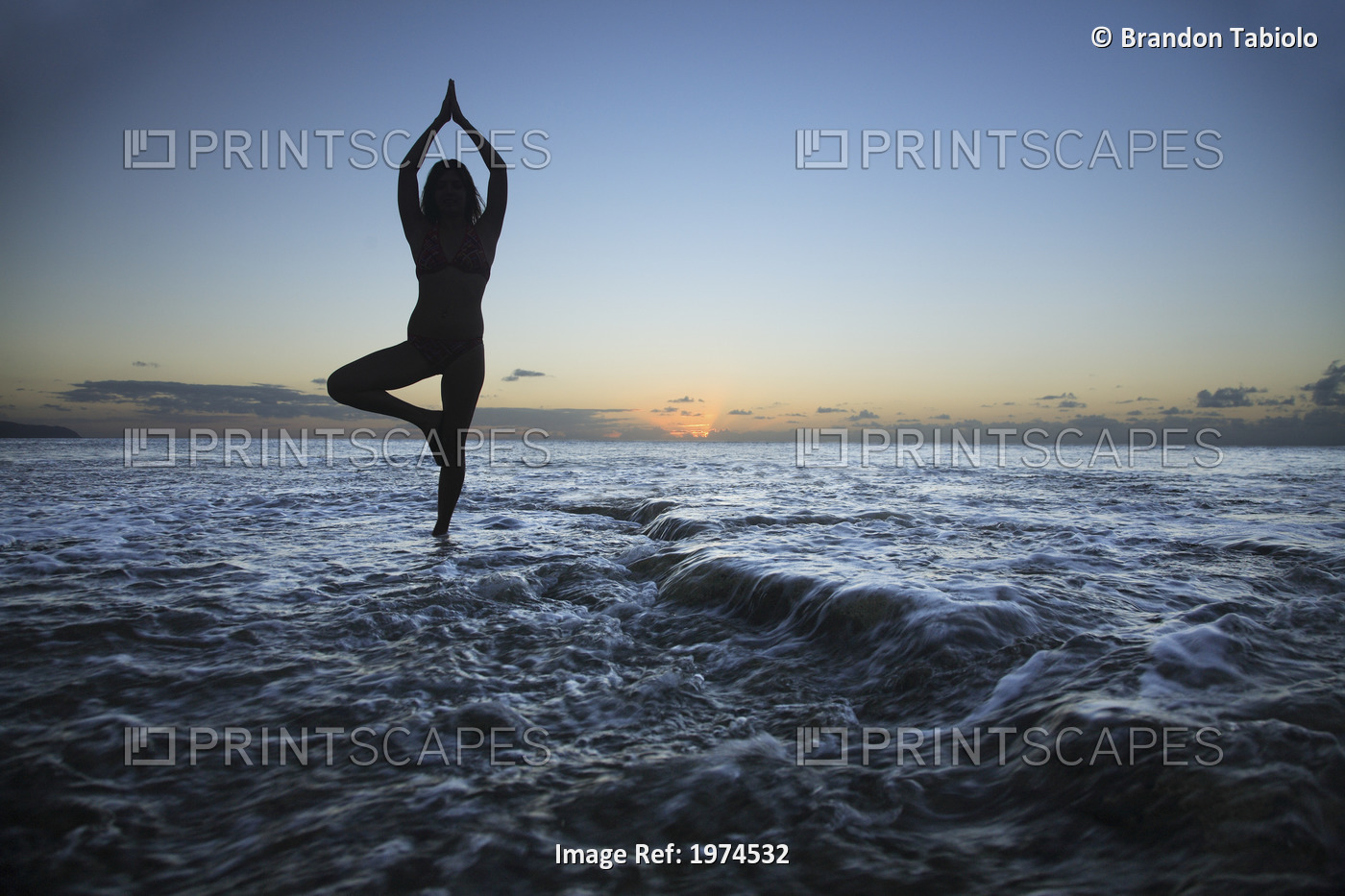 Hawaii, Oahu, Fit Young Girl On The Beach Doing Yoga On The Rocky Coastline.