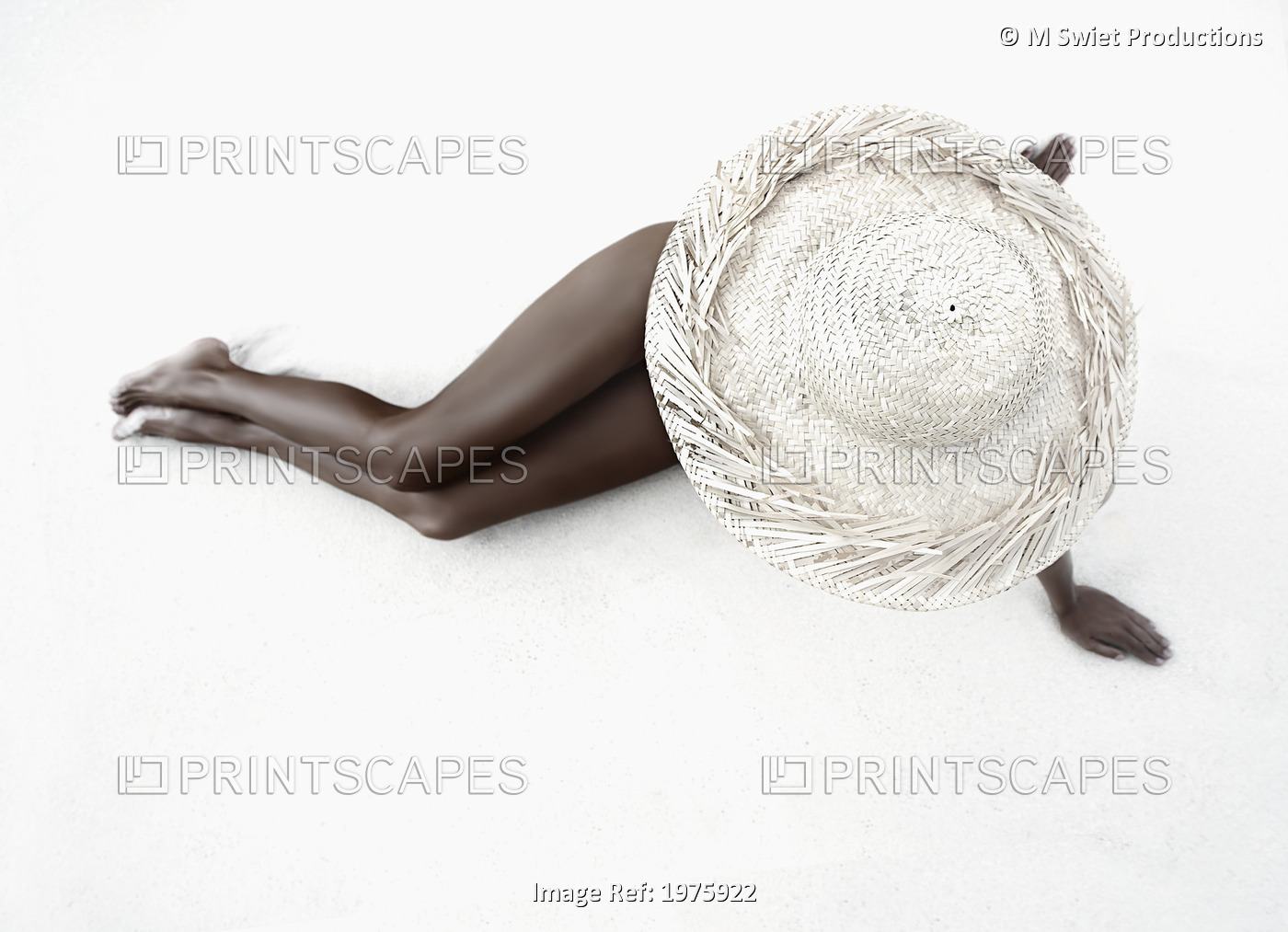 Hawaii, Woman Lays On The Sand With Straw Wide Brim Hat.