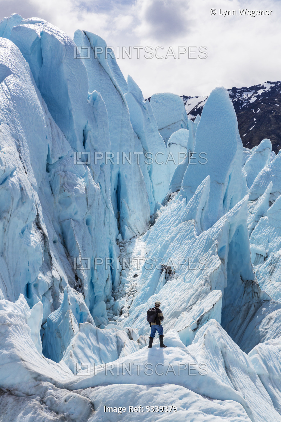 Hiker Standing On At The Base Of Matanuska Glacier, Southcentral Alaska, Summer