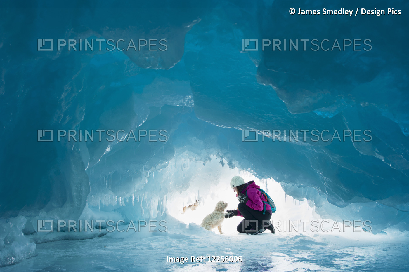 Woman With Her Pet Dog Inside A Natural Ice Cave On Frozen Lake Superior In ...