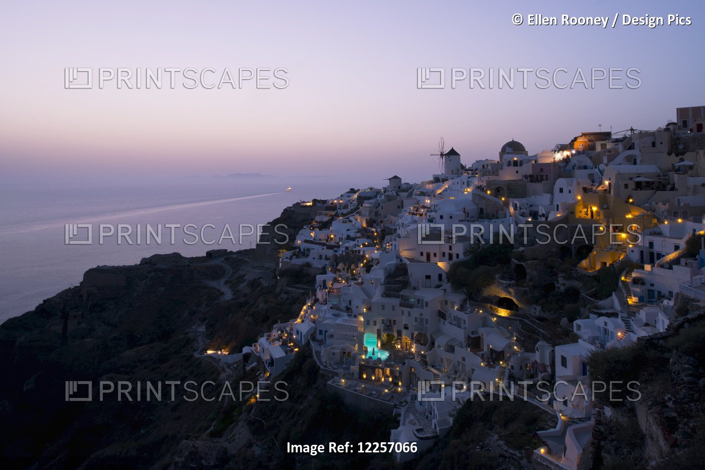 An Aerial View Of Oia And The Windmill At Dusk; Oia, Santorini, The Cyclades, ...