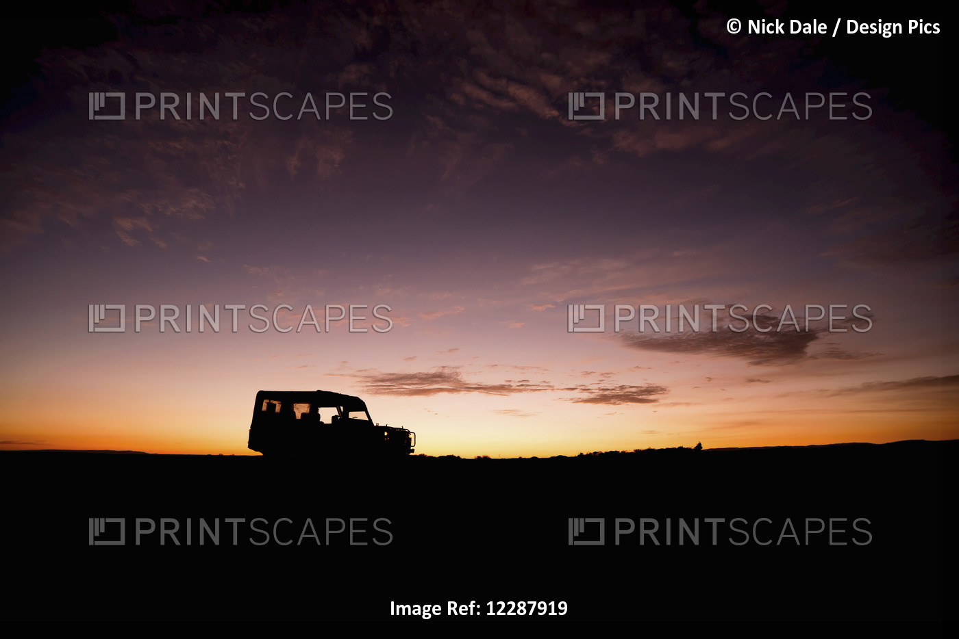 A Truck Parked On The Savannah With It's Headlights On Is Shown In Silhouette ...