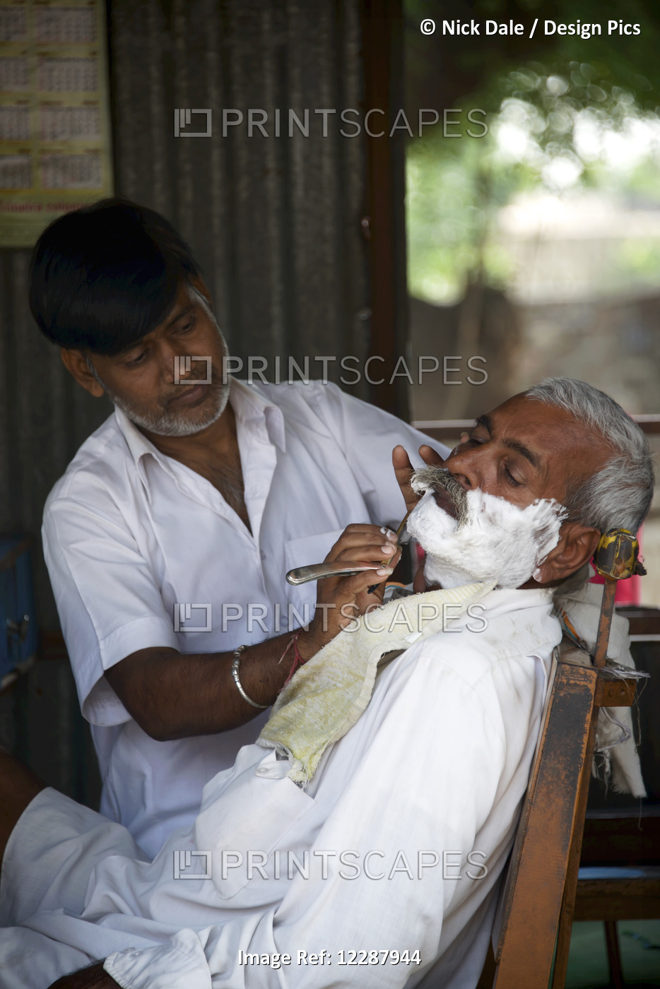 Barber Shaving Indian Man; Dharpatha Mal, Madhya Pradesh, India