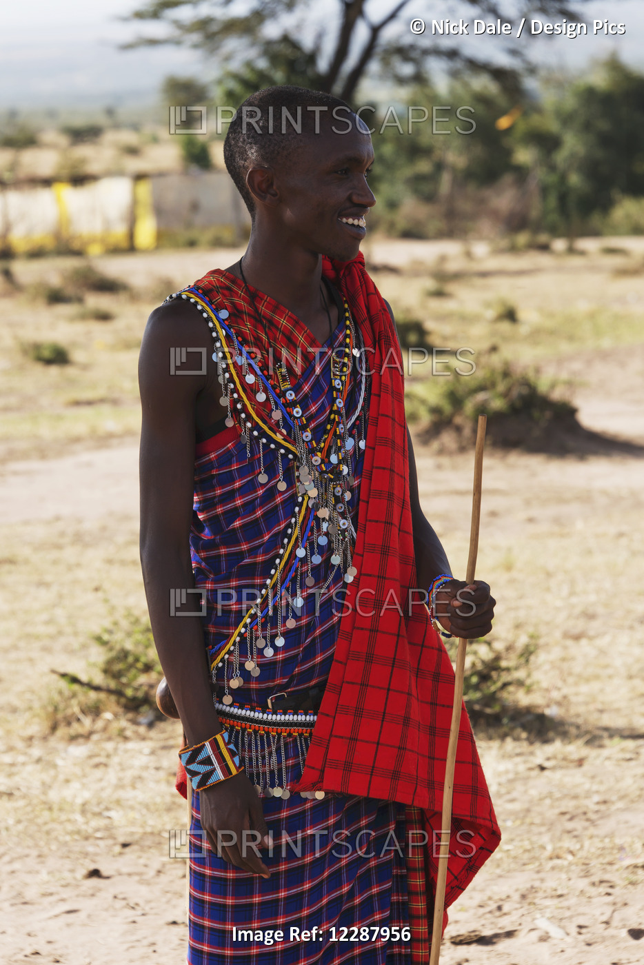A Young Masai Man Dressed In A Traditional Costume Of Blue, Black And Red ...