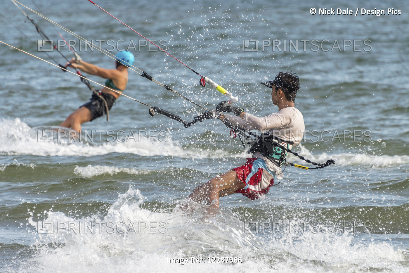 Male And Female Kite Surfers; New Territories, Hong Kong, China