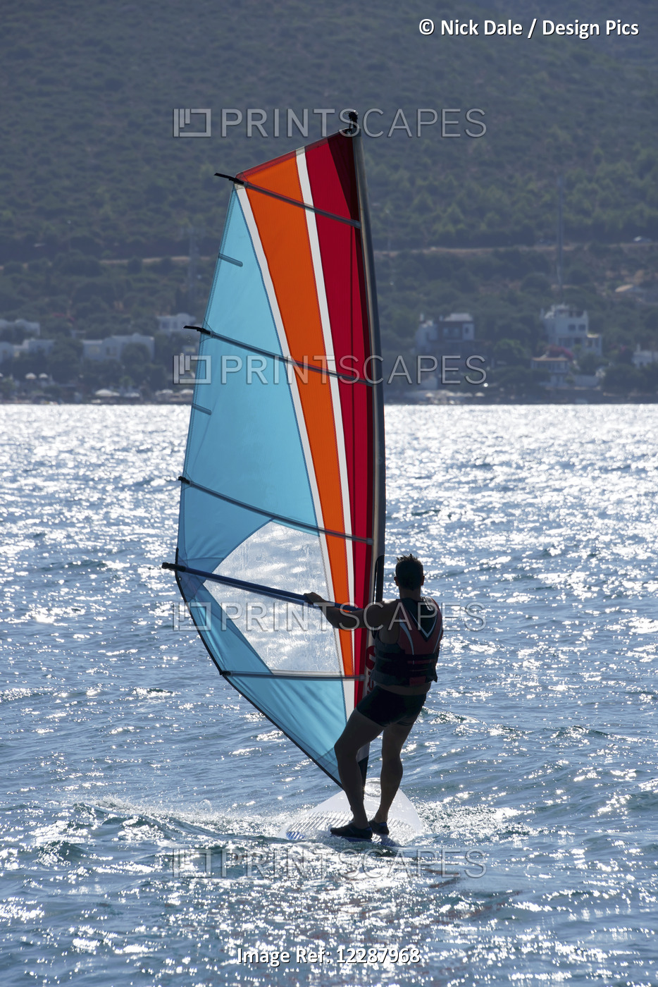 Windsurfing With Sunlight Reflected On The Water And A View Of The Shoreline; ...