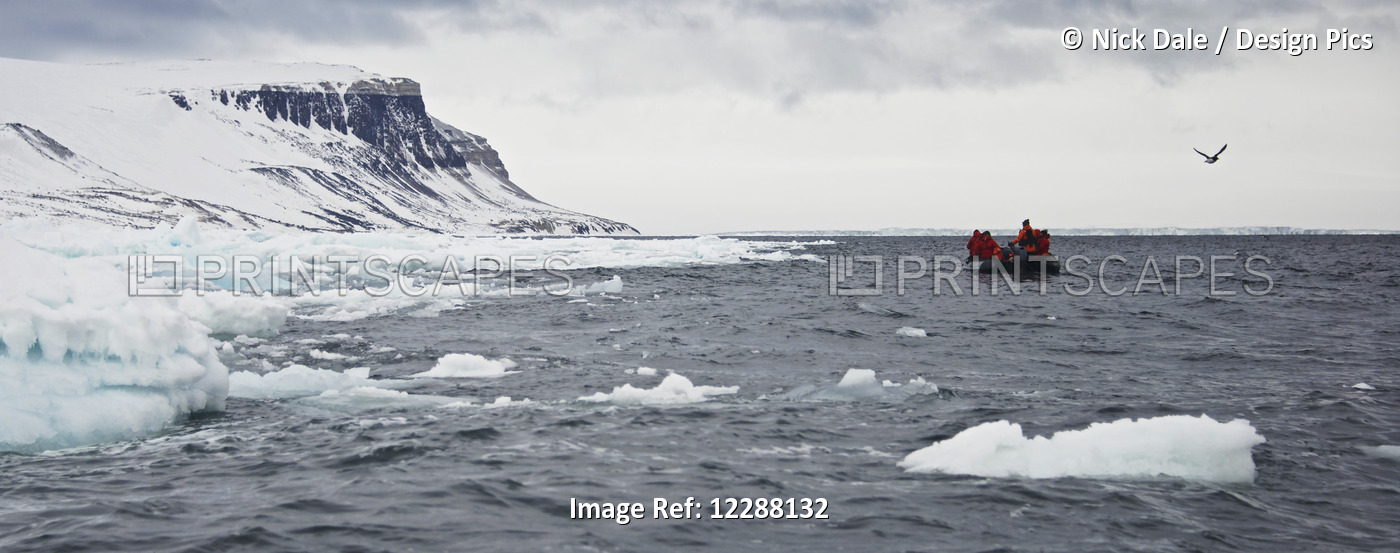 People Riding In An Inflatable Boat In The Arctic Ocean With A View Of The ...