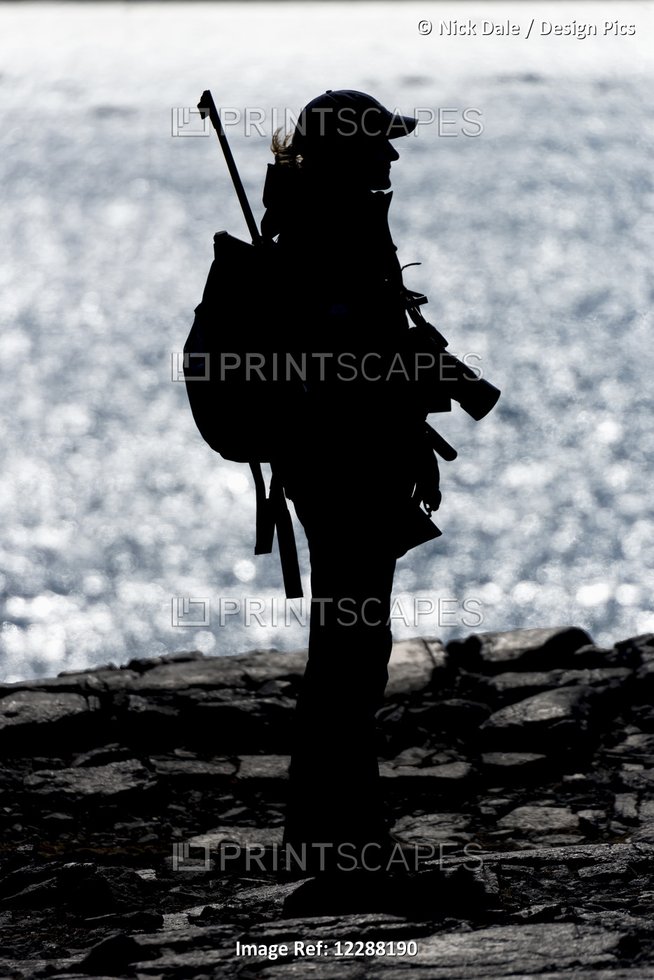 Underexposed Silhouette Of A Woman In A Peaked Cap Carrying A Backpack, Camera ...