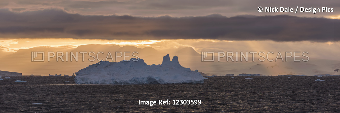 Jagged Iceberg In Silhouette Against Dawn Sky; Antarctica
