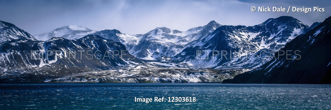 Snowy Mountains In Sunshine Beside Blue Sea; Antarctica