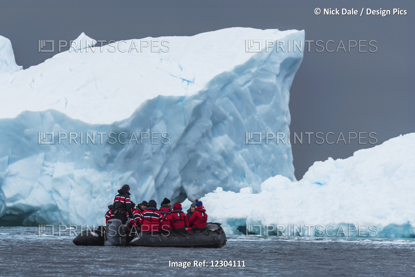 Black Inflatable Boat Motoring Past Ice Cliff; Antarctica