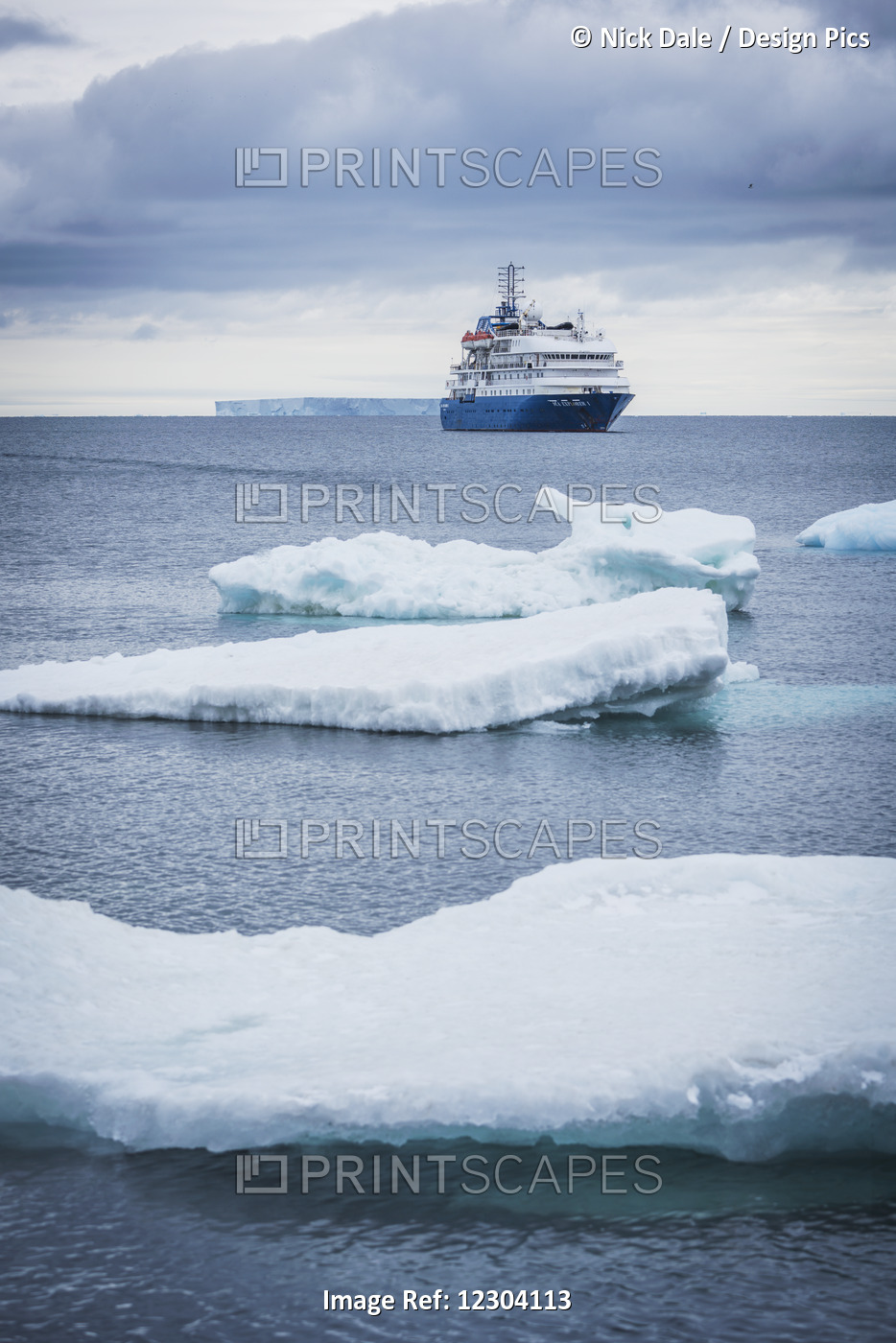 Cruise Ship Anchored With Icebergs In Foreground; Antarctica