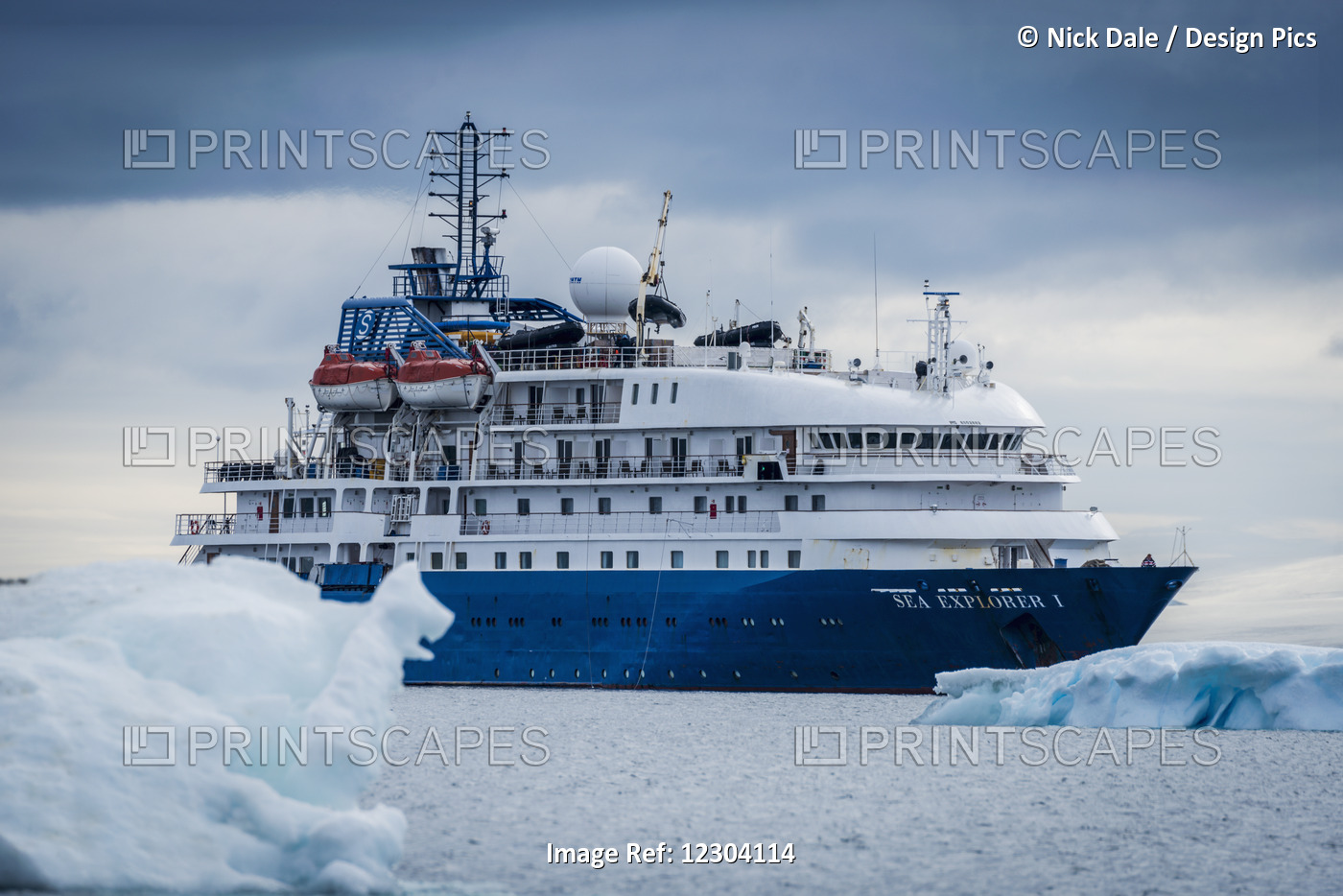 Cruise Ship At Anchor Between Blue Icebergs; Antarctica