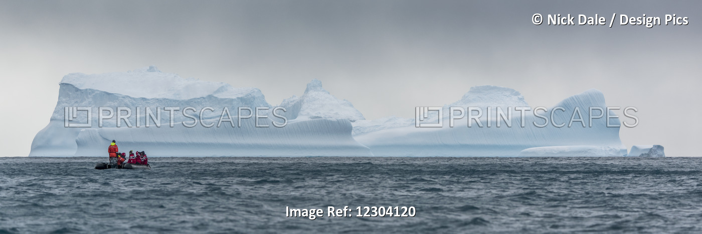 Inflatable Cruises Towards Blue Iceberg On Horizon; Antarctica
