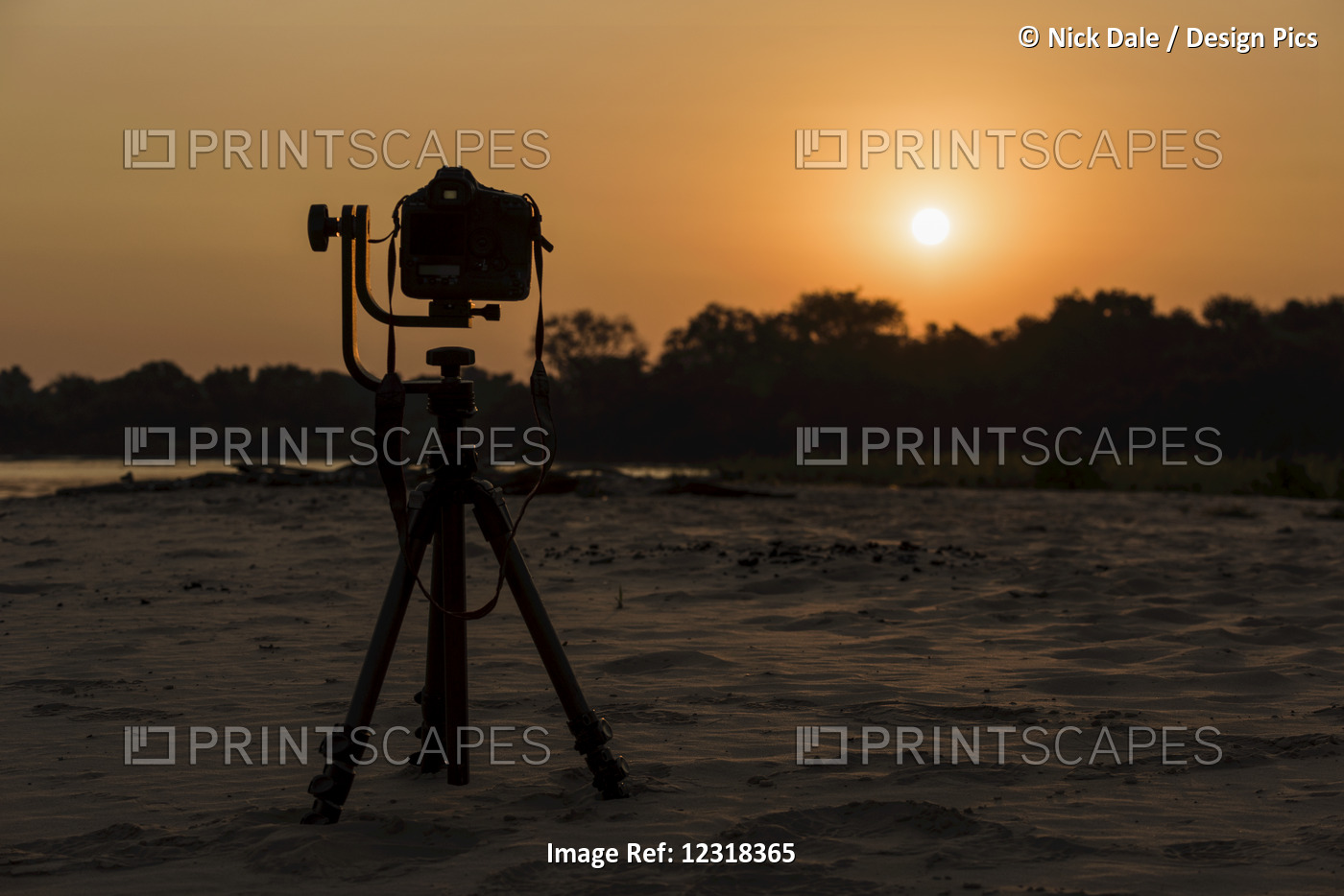 Camera On Tripod Beside River At Sunset; Mato Grosso Do Sul, Brazil
