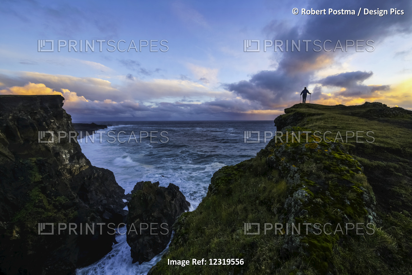 Person Standing On A Cliff Face While The Atlantic Ocean Pounds The Shores ...
