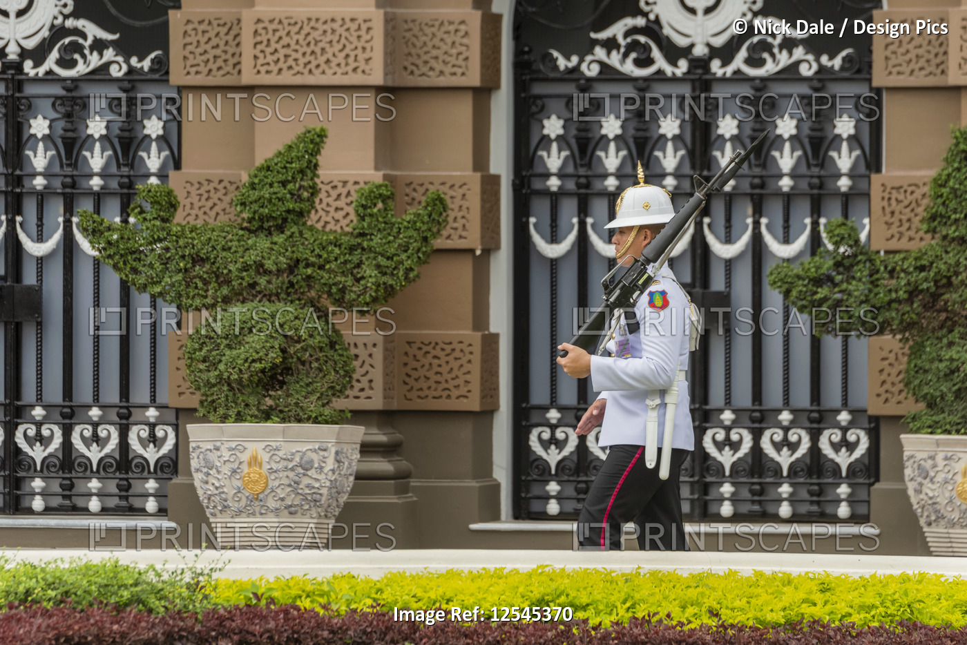 White-jacketed Grand Palace soldier marching with rifle, Grand Palace; Bangkok, ...