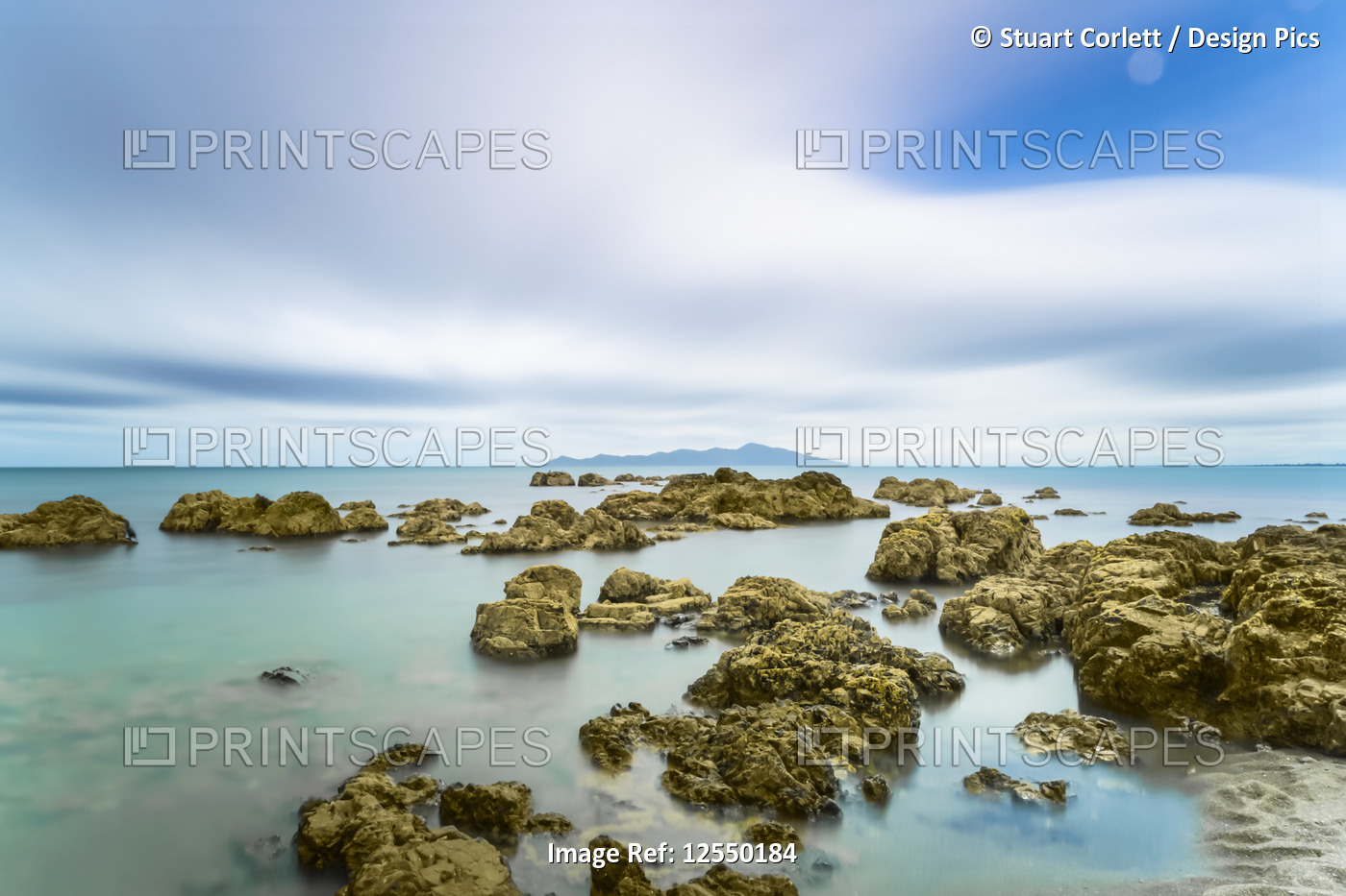 Rocks in the ocean along the shoreline in Pukerua Bay, Kapiti Island; ...